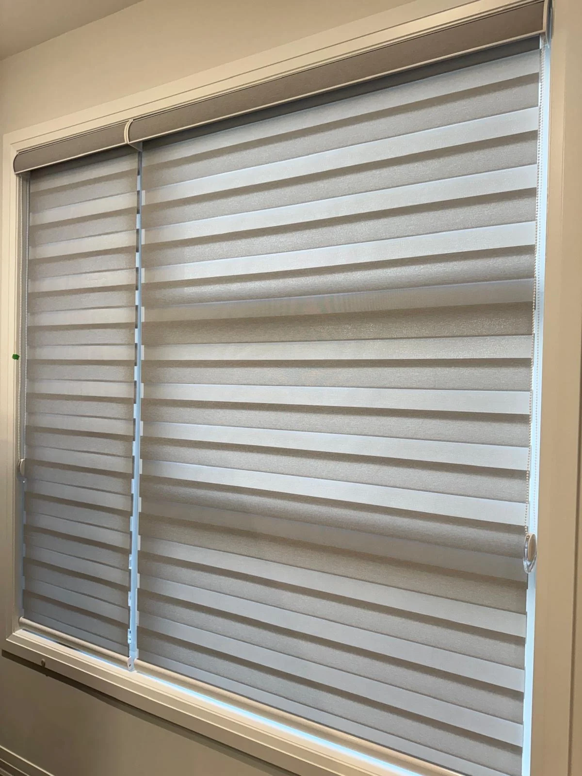 Close view of layered zebra shade fabric at a window