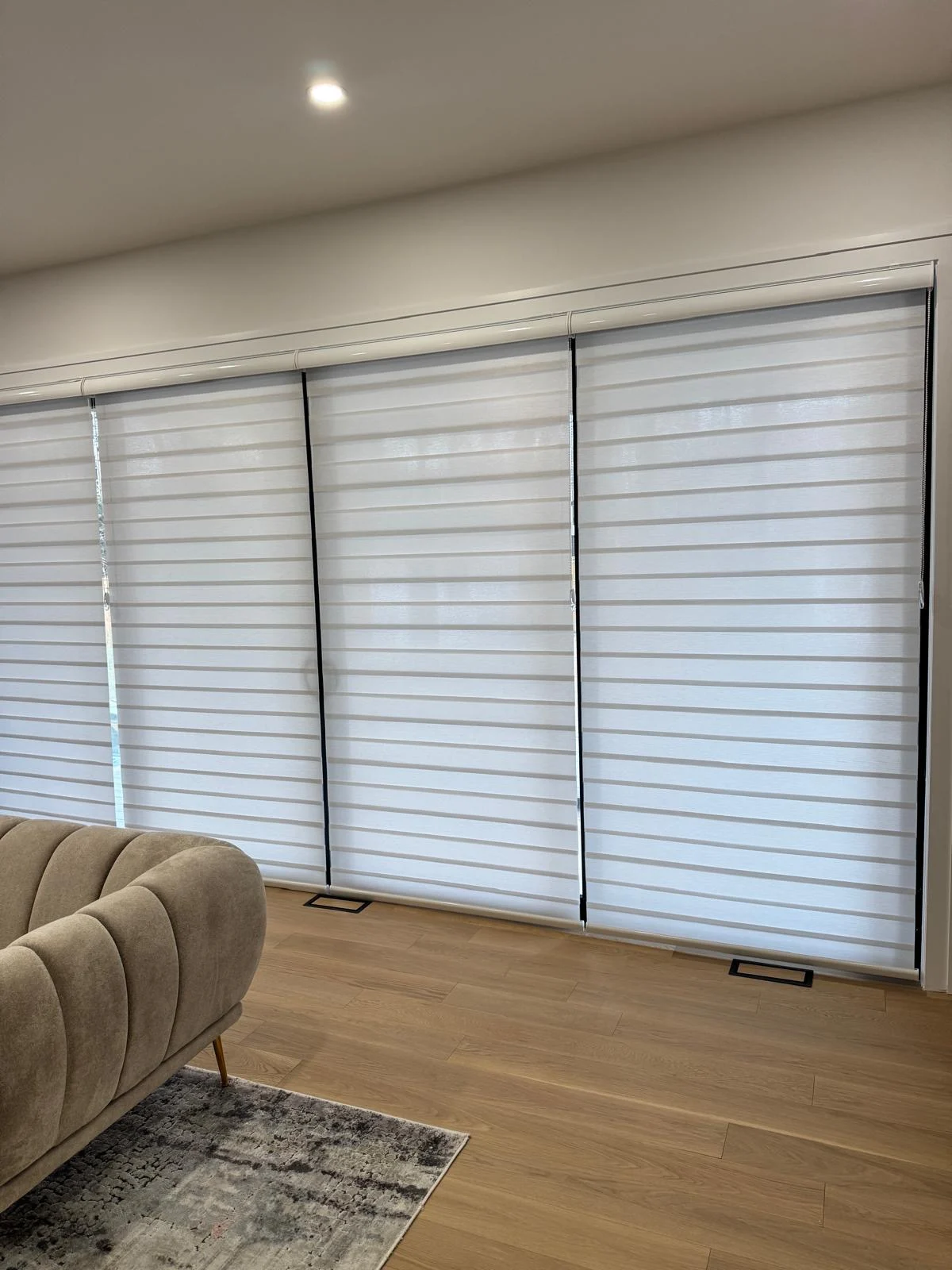 Custom zebra shades fitted across living room windows